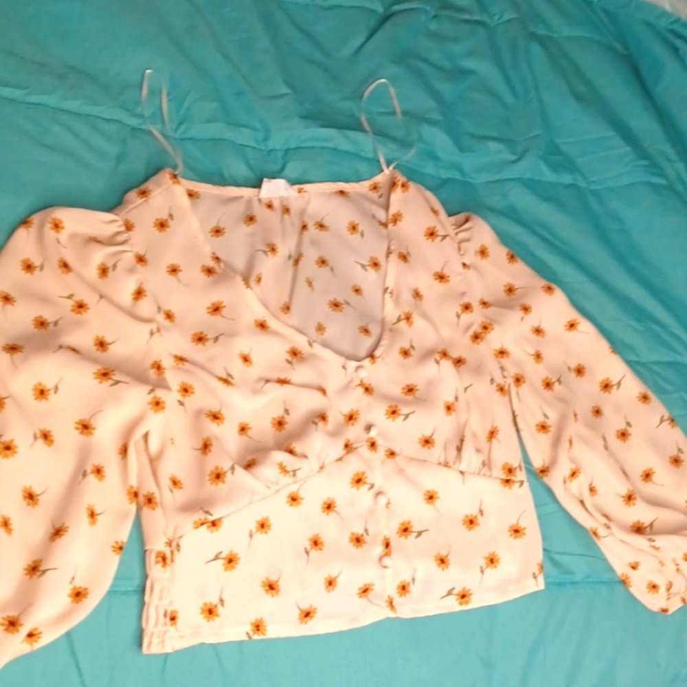 I am selling a shirt that is a size Small, the colors are white with sunflowers